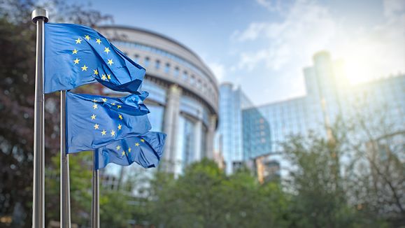 European union flag against parliament in Brussels, Belgium