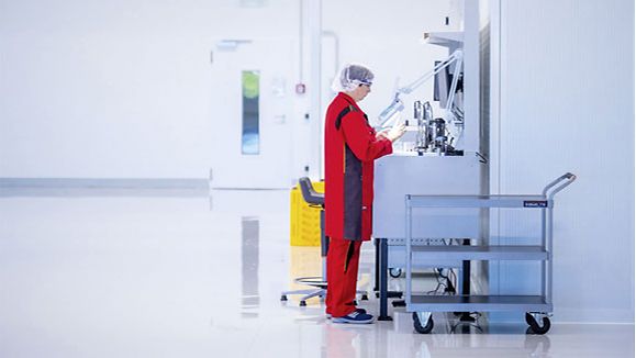 In the production hall of Swiss medtech company Ypsomed, technician Liane Haberland examines a cartridge holder for insulin syringes.