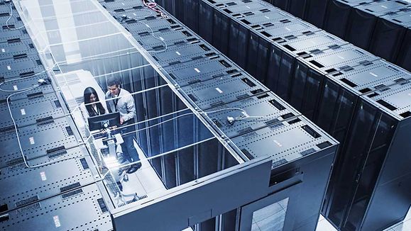 High angle view of technicians working in server room.