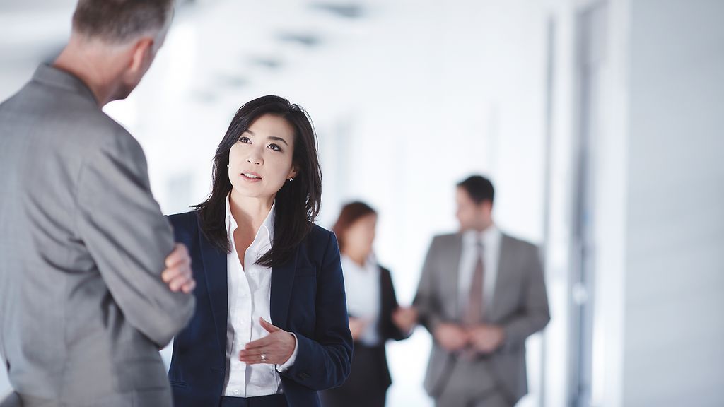 Business people talking in office corridor