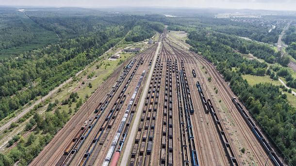 Depot with many railways at day in city at sunny day. View from above.