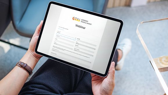 Top view mockup image of a woman holding digital tablet with blank white desktop screen in cafe