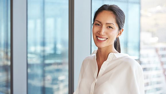 Portrait Of Businesswoman Standing By Window In Office