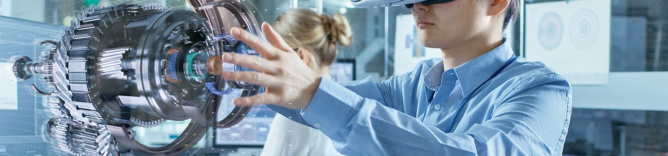 Computer Science Engineer wearing Virtual Reality Headset Works with 3D Model Hologram Visualization, Makes Gestures. In the Background Engineering Bureau with Busy Coworkers.